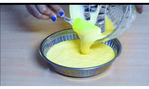 Transferrring dhokla batter in greased pan