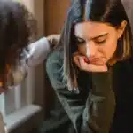 a woman talking to a friend about stressful situations