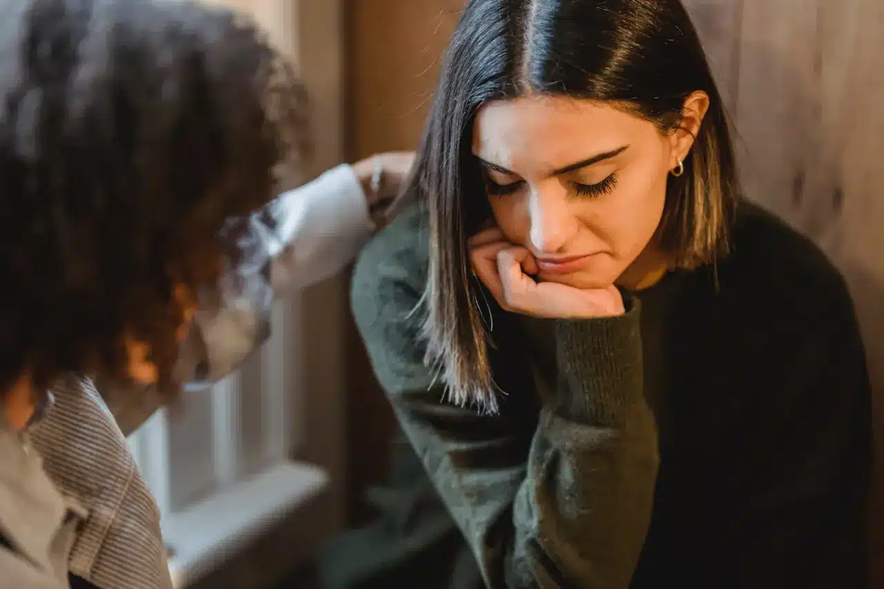 a woman talking to a friend about stressful situations