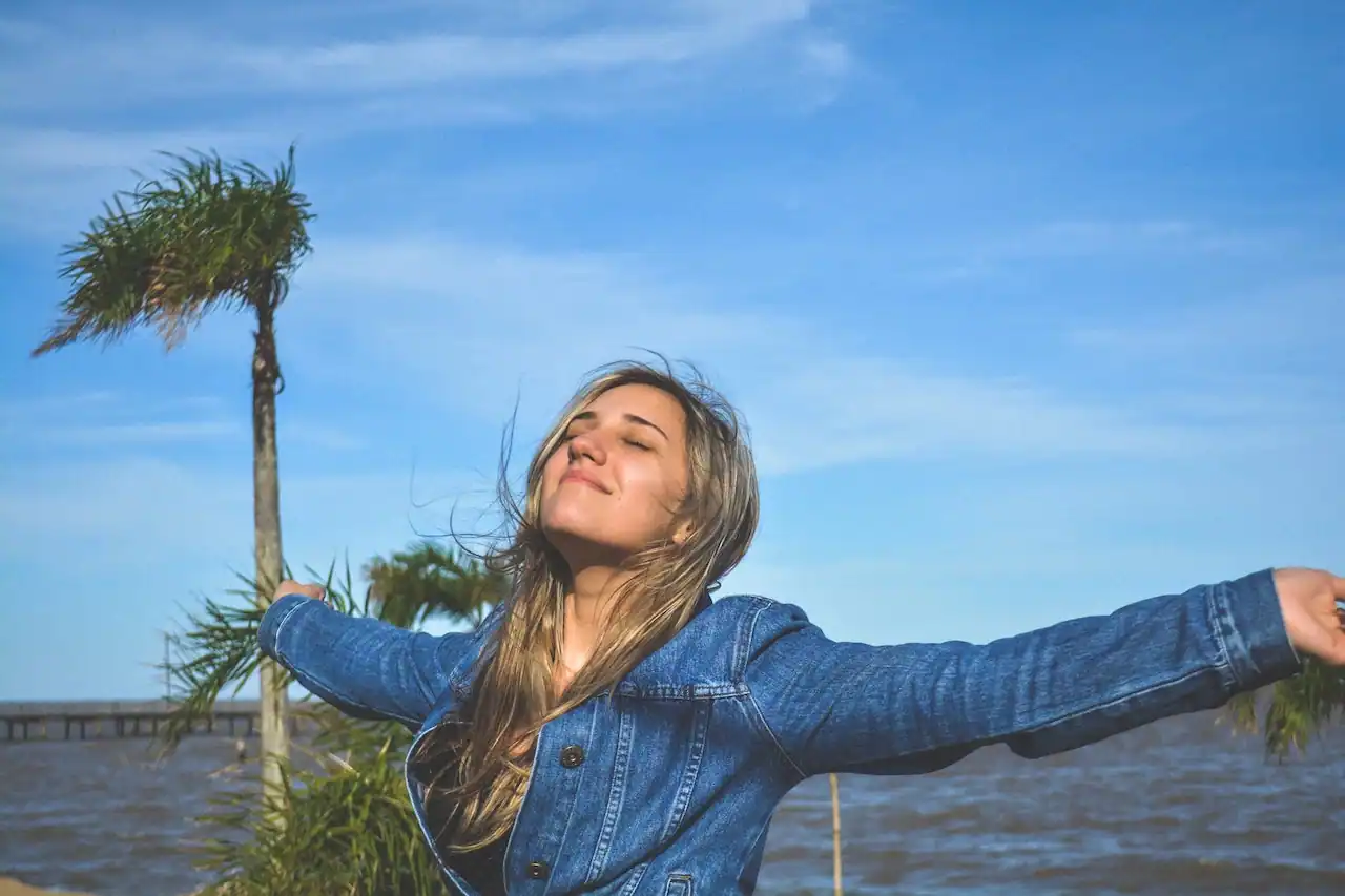 A happy woman with outstretched arms.