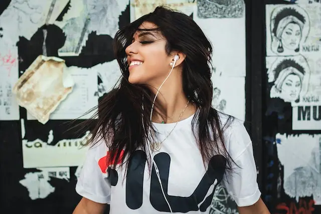 Woman smiling while listening to music on her headphones