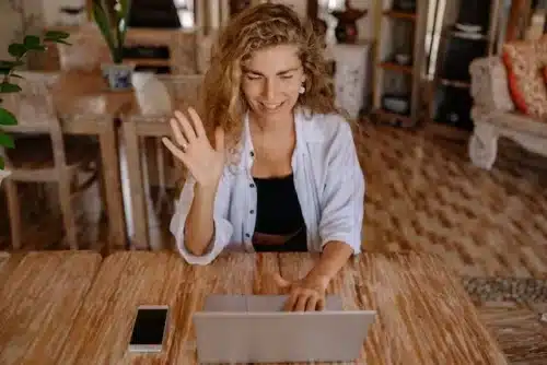 A woman having a video call while sitting alone at a desk