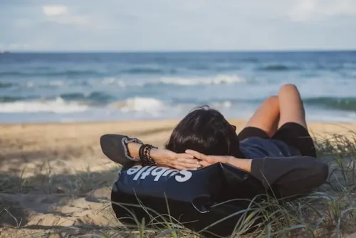 a woman lying on a beach and relaxing