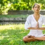 Woman harnessing nature’s wisdom for physical and emotional well-being in a healing garden