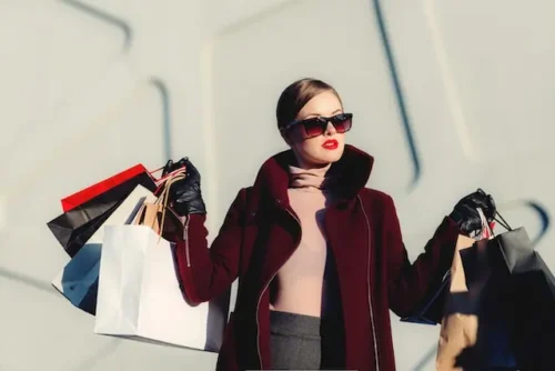 Woman carrying a lot of bags after shopping Conscious Consumerism