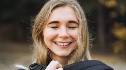 Woman smiling and visualizing her long-term goals