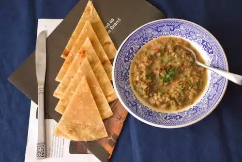 lentil soup with naan bread on the side