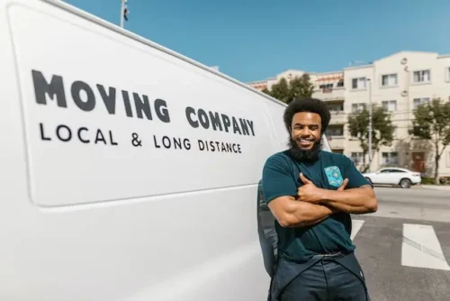 Man standing in front of a moving company van