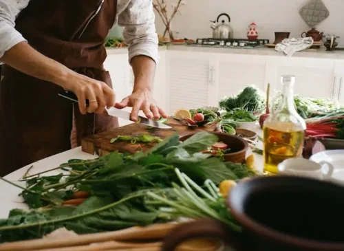 Close-up shot of a man cutting vegetables in the design your dream kitchen.