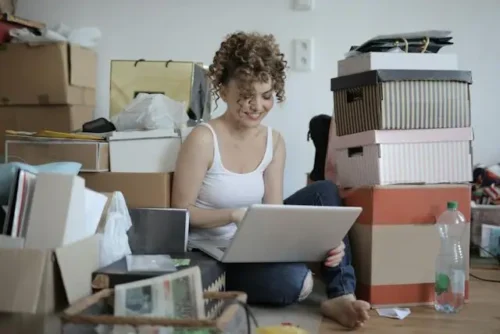 Woman Using Laptop On The Floor