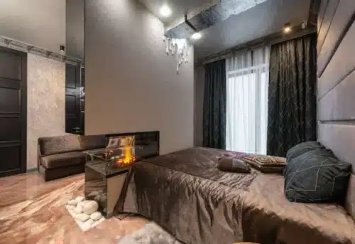 Modern bedroom with smart fireplace represents modern living space.