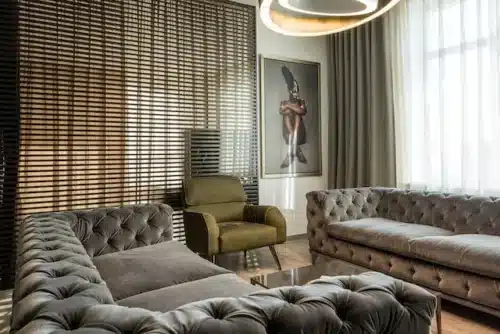 Stylish area with gray sofas and seaweed armchair