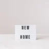 Words New Home on a white box