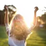 A happy woman running in a field