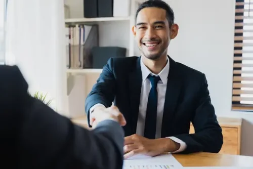 Consulting candidate walking confidently on interview day with laptop in hand