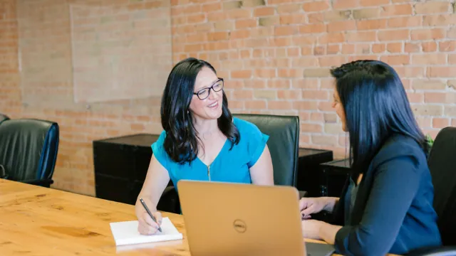 Consulting candidates participating in a structured interview meeting in a modern office