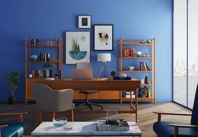 A room with a desk and bookshelves