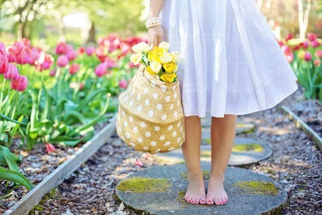A person holding a bag of flowers