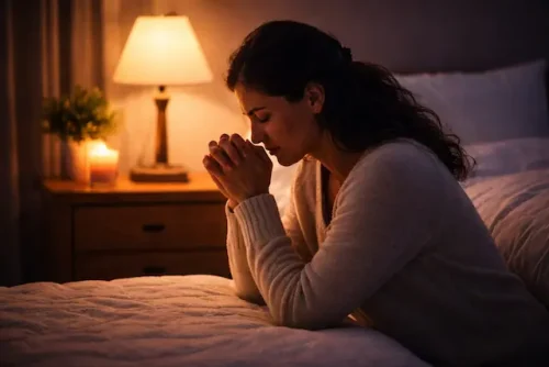 Person praying at night for peace and comfort using Bible verses for anxiety and fear at night