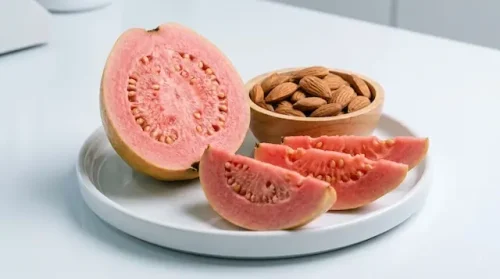 Can diabetics eat guava to lower blood sugar? Close-up of fibrous sliced guava next to almonds.