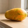 Ripe papaya with yellow and yellow-orange skin showing signs of papaya ripeness